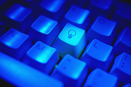 Blue keyboard with lightbulb on one key